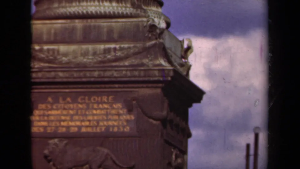 1939 Paris 8mm frame holding on the monument inscription and decorative base, with sky and film gate edges visible.