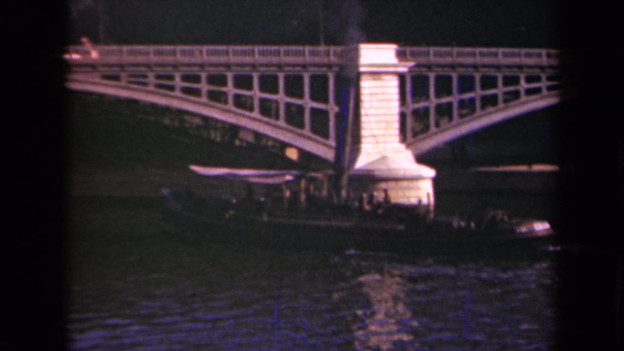 Arched bridge over water with a smoking boat near the bridge pier.