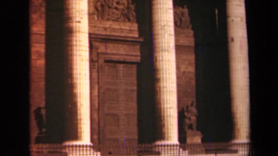1939 Paris 8mm frame showing tall fluted columns, carved stonework, and a large doorway on a monumental facade.