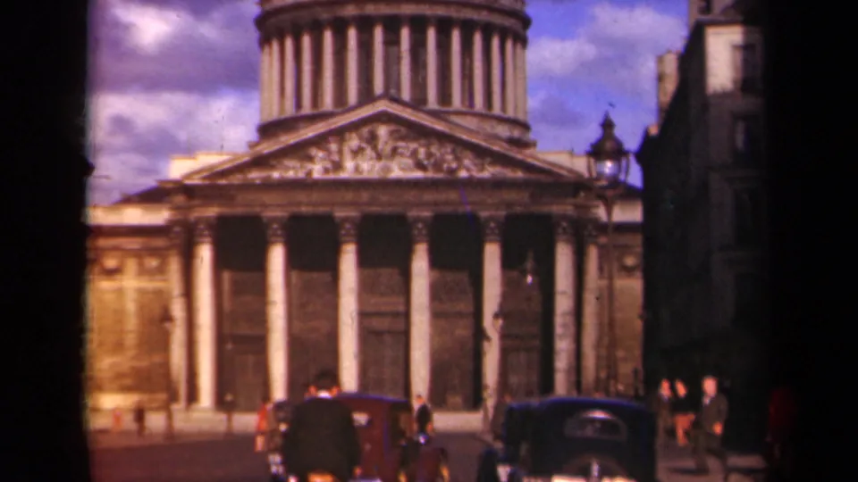 1939 Paris 8mm frame showing the domed portico, columns, automobiles, and small figures walking near the landmark.