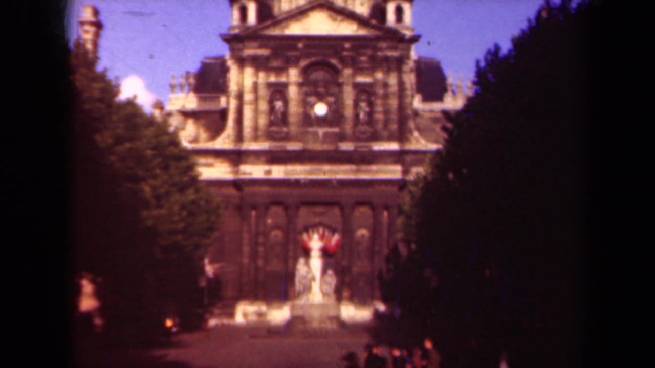 1939 Paris view of Hôtel des Invalides framed by trees, with ornate stone facade and a central statue or fountain below.