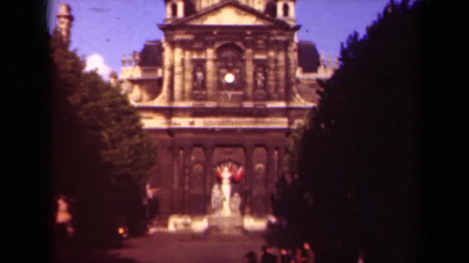 1939 Paris view of Hôtel des Invalides framed by trees, with ornate stone facade and a central statue or fountain below.