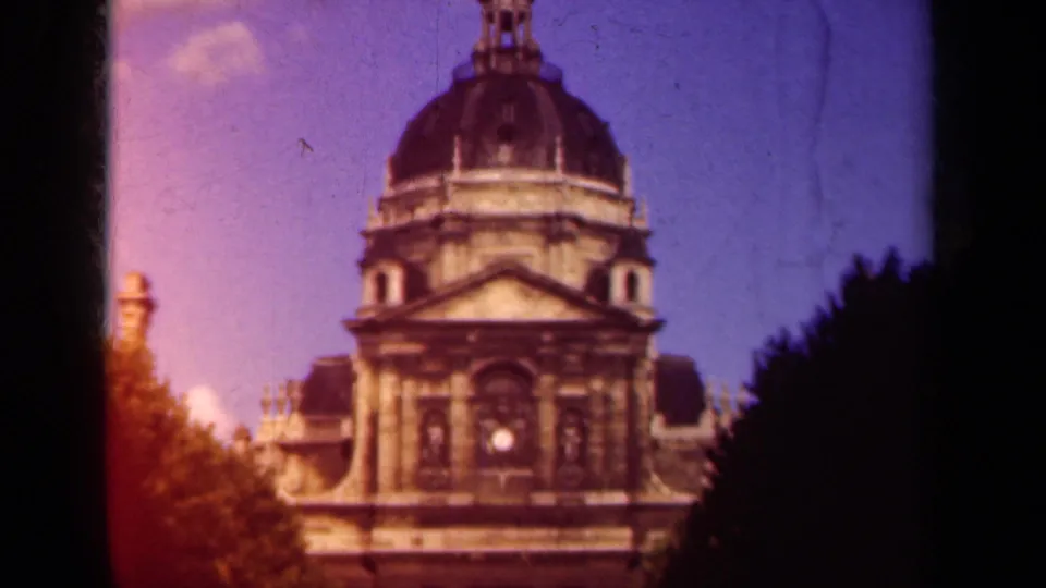 The upward pan reaches more of the dome and upper facade, with Paris location supported by clip metadata and visible 8mm color fading.