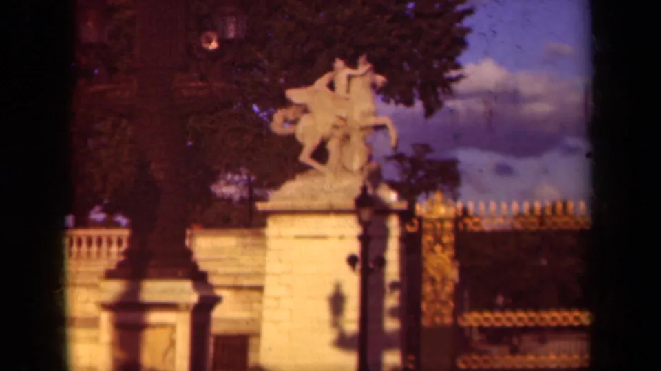 1939 Paris frame with the equestrian statue and pedestal centered near a dark lamppost, backed by trees and decorative railings.