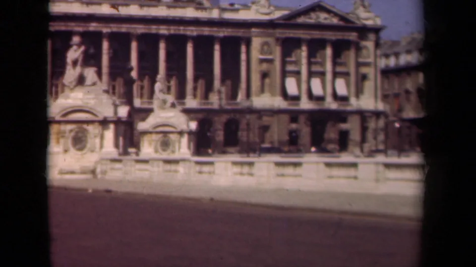 1939 Paris home-movie view of a large columned building, sculptural details, balustrade, and open roadway.