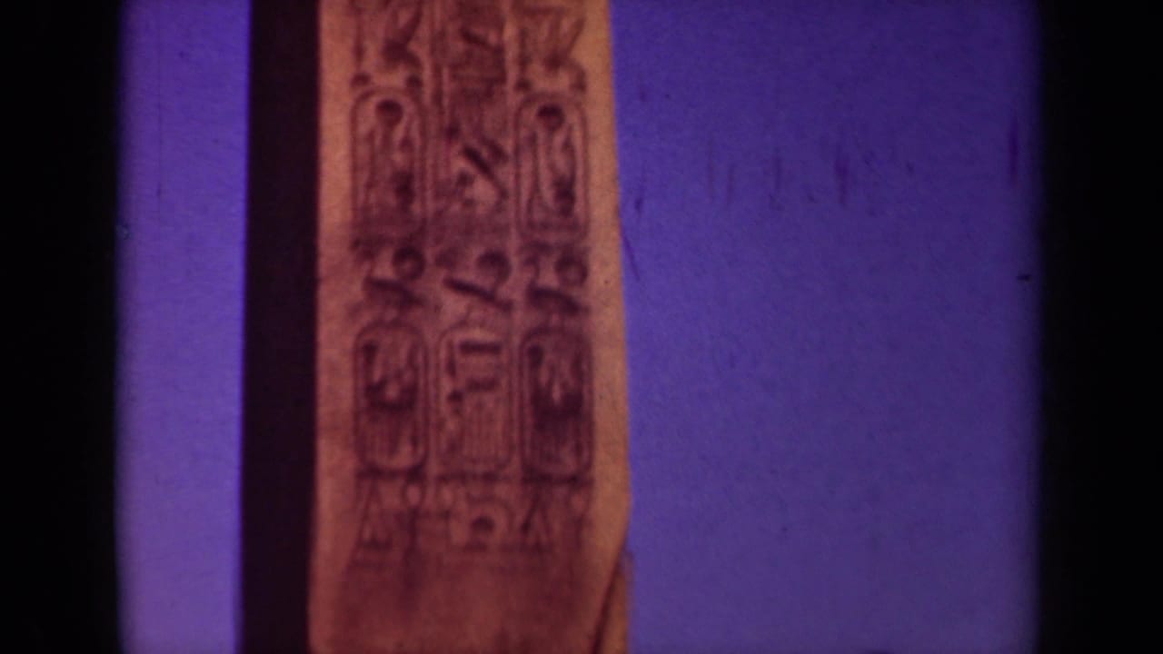 Close view of a tall carved obelisk face with hieroglyph-like markings.