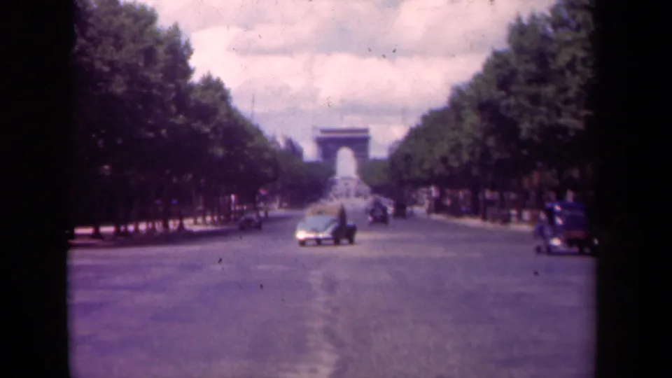 Final frame of the 1939 Paris street view, showing sparse cars on the Champs-Elysees and the Arc de Triomphe centered beyond the trees.