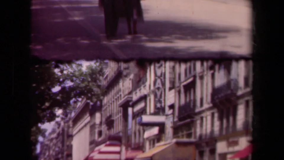 The 1939 Paris street view is partly obscured by film edge shadow, with shop awnings, upper facades, and a nearby pedestrian visible.