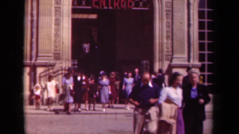 Men and women in period attire cross the foreground as others stand near the Paris entrance marked ENTREE.