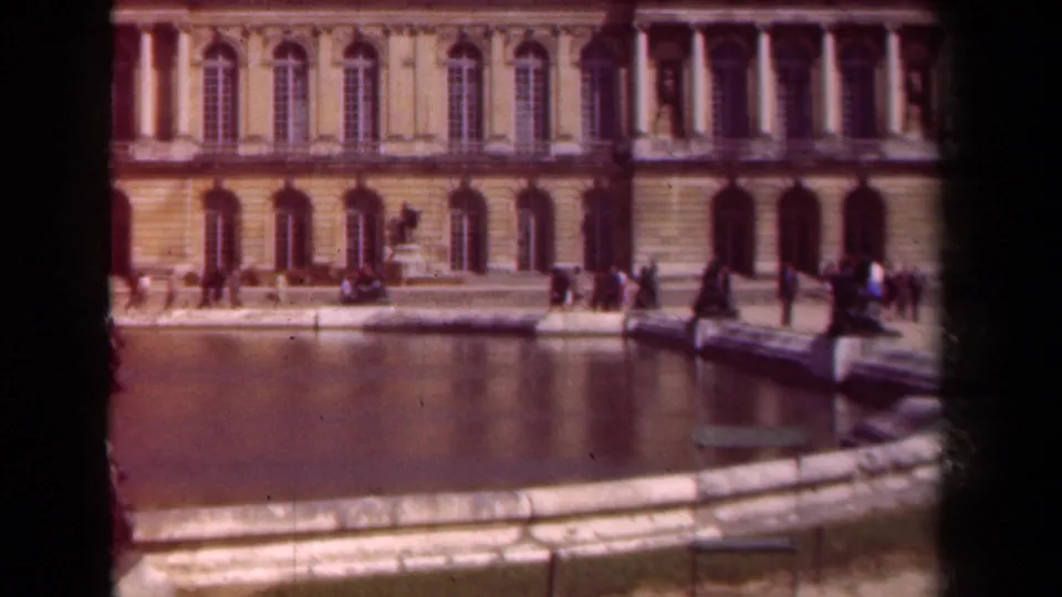 Supplied 1939 Paris footage shows small groups near a reflecting pool and arched palace windows in warm faded color.