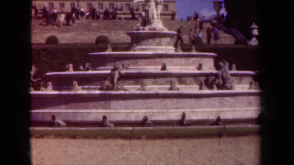 1939 Paris frame of a large marble fountain, classical sculpture, upper terrace visitors, and visible 8mm gate edge.