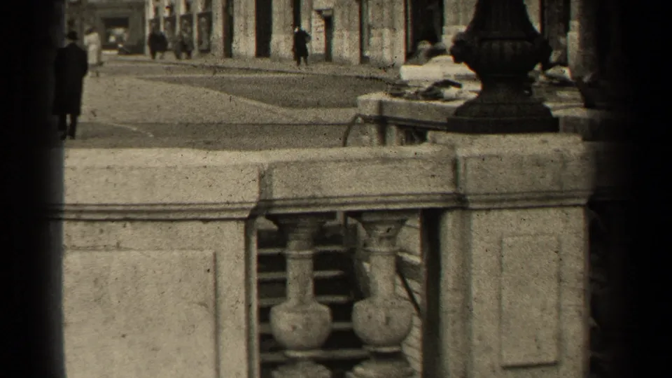 1947 Paris street scene with pedestrians, a car partly visible near the curb, stone facades, railing, and dark 8mm edge shadow.