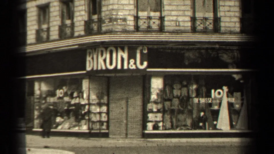1947 Paris corner shop exterior marked BYRON & C, with display windows, sale signage, and pedestrians passing on the street.
