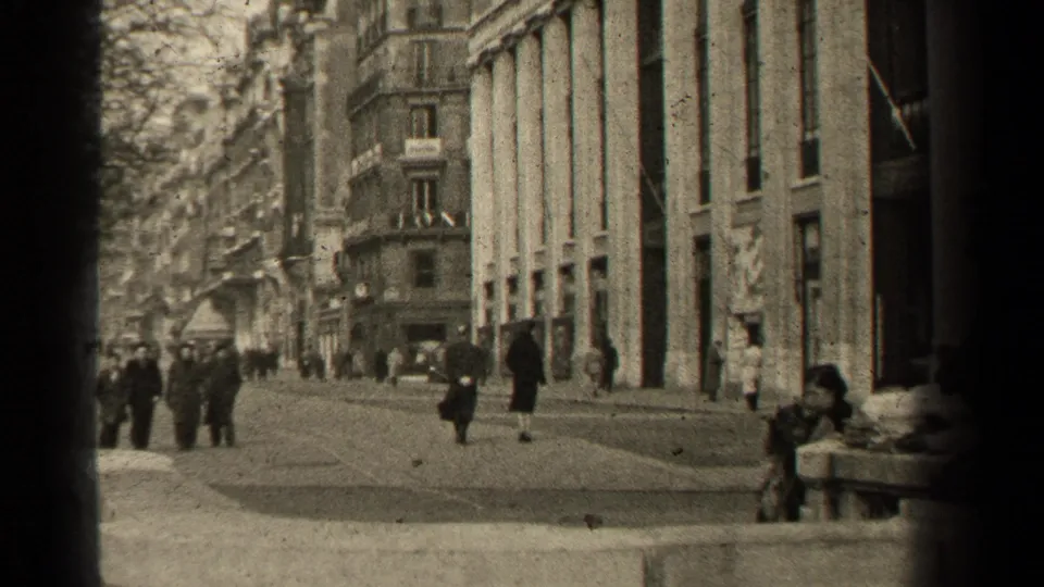 Paris in 1947, with pedestrians gathered near a broad sidewalk and grand stone architecture.