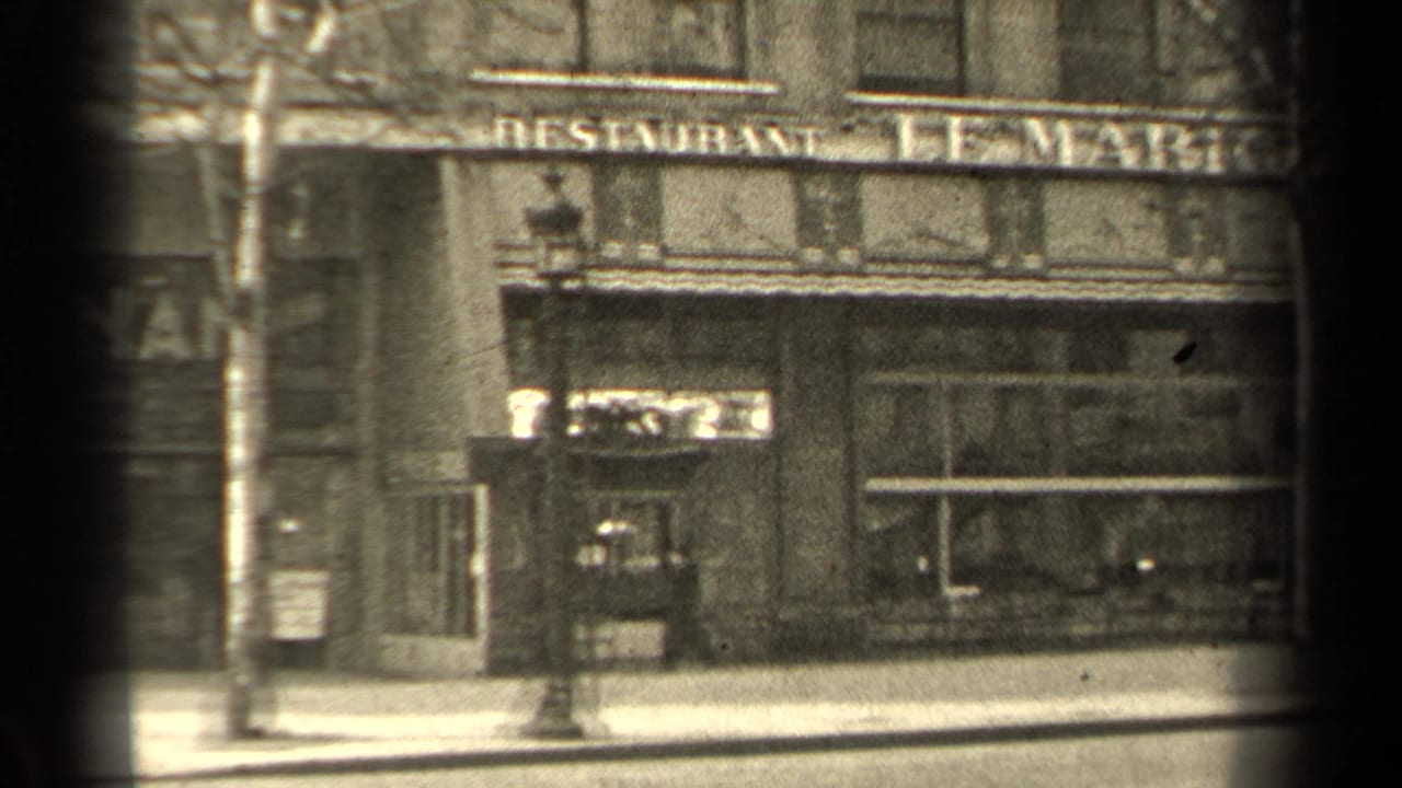 Street-level restaurant storefront with Le Marignan sign, bare trees, and sidewalk.