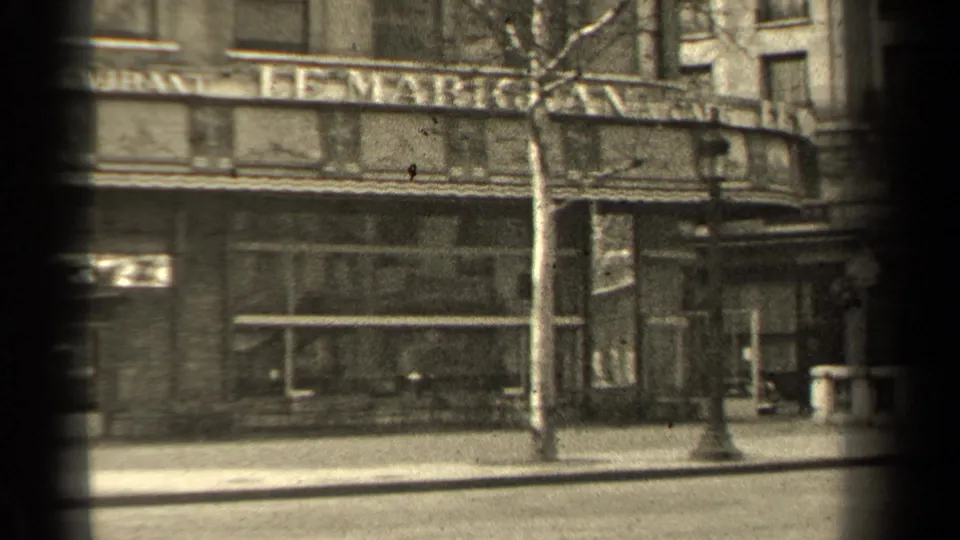 Paris storefront facade in 1947 with Le Marignan signage partly visible, a bare tree, lamppost, and empty street foreground.