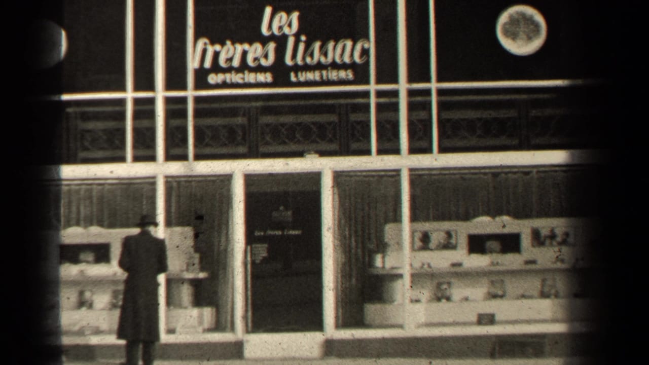 The man remains near the Paris optician display, with the shop name and glass-fronted facade visible.