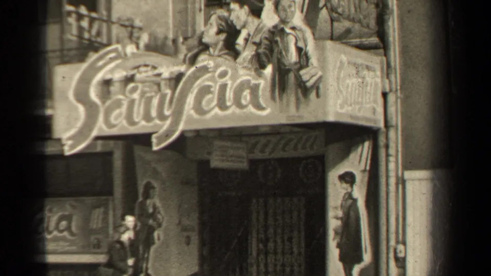 1947 Paris street view showing a theater facade, large display sign, poster art and pedestrians near the sidewalk.