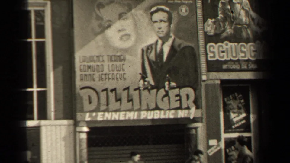 1947 Paris theater exterior with a prominent Dillinger poster, adjacent Sciuscia poster, windows and dark foreground edge.