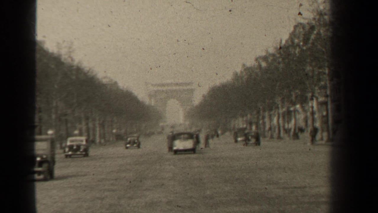 Cars and small pedestrian figures appear on a broad avenue leading toward the Arc de Triomphe.