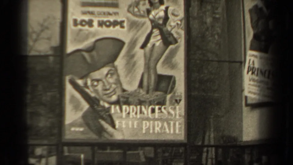 1947 Paris frame showing a large poster for Bob Hope's La Princesse et le Pirate beside a boulevard view.