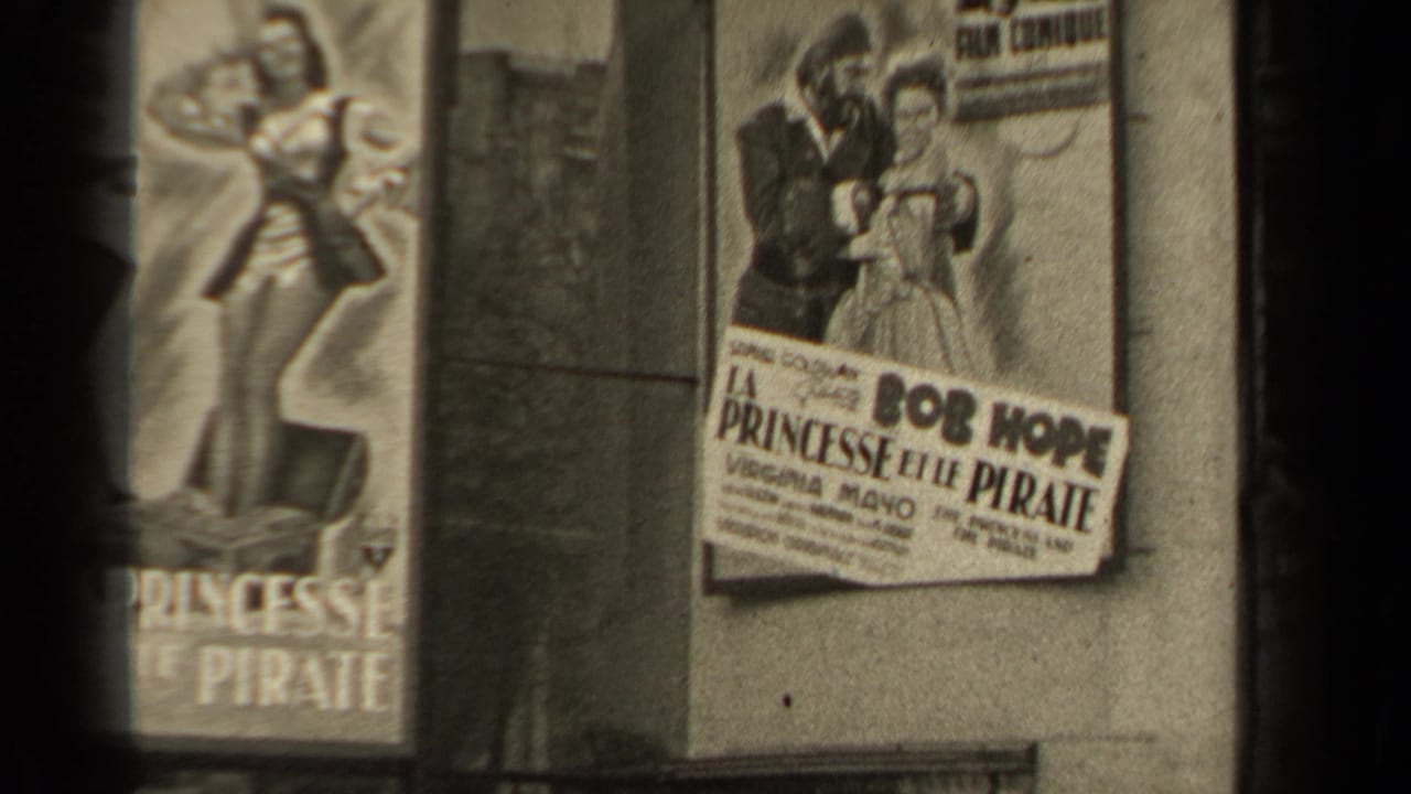 A French poster for La Princesse et le Pirate is seen on a wall, naming Bob Hope and Virginia Mayo with illustrated characters above the title.