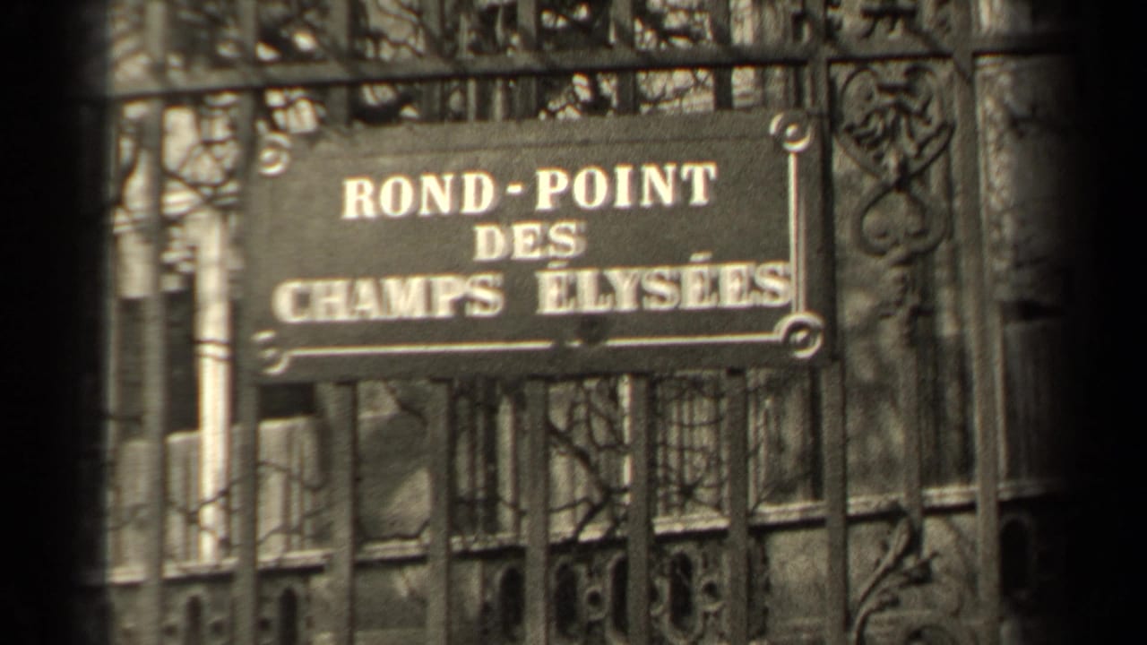Close 8mm view of the Rond-Point des Champs Elysees sign in Paris, partially blocked by dark iron bars.