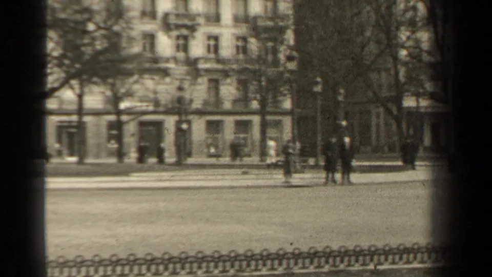 1947 Paris street scene near the Rond-Point des Champs Elysees with pedestrians, bare trees, and building facades.