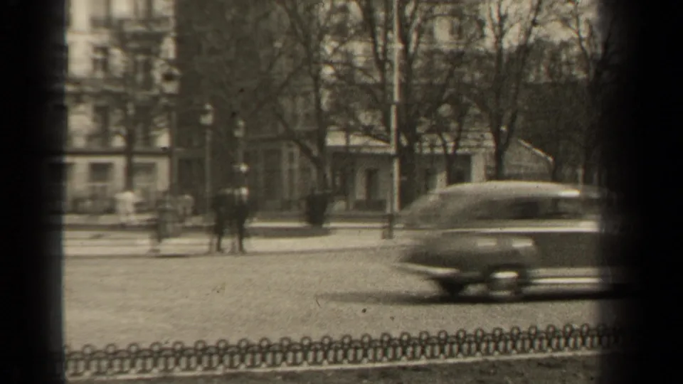 A mid-century car passes through the 1947 Paris street view near the Rond-Point des Champs Elysees.
