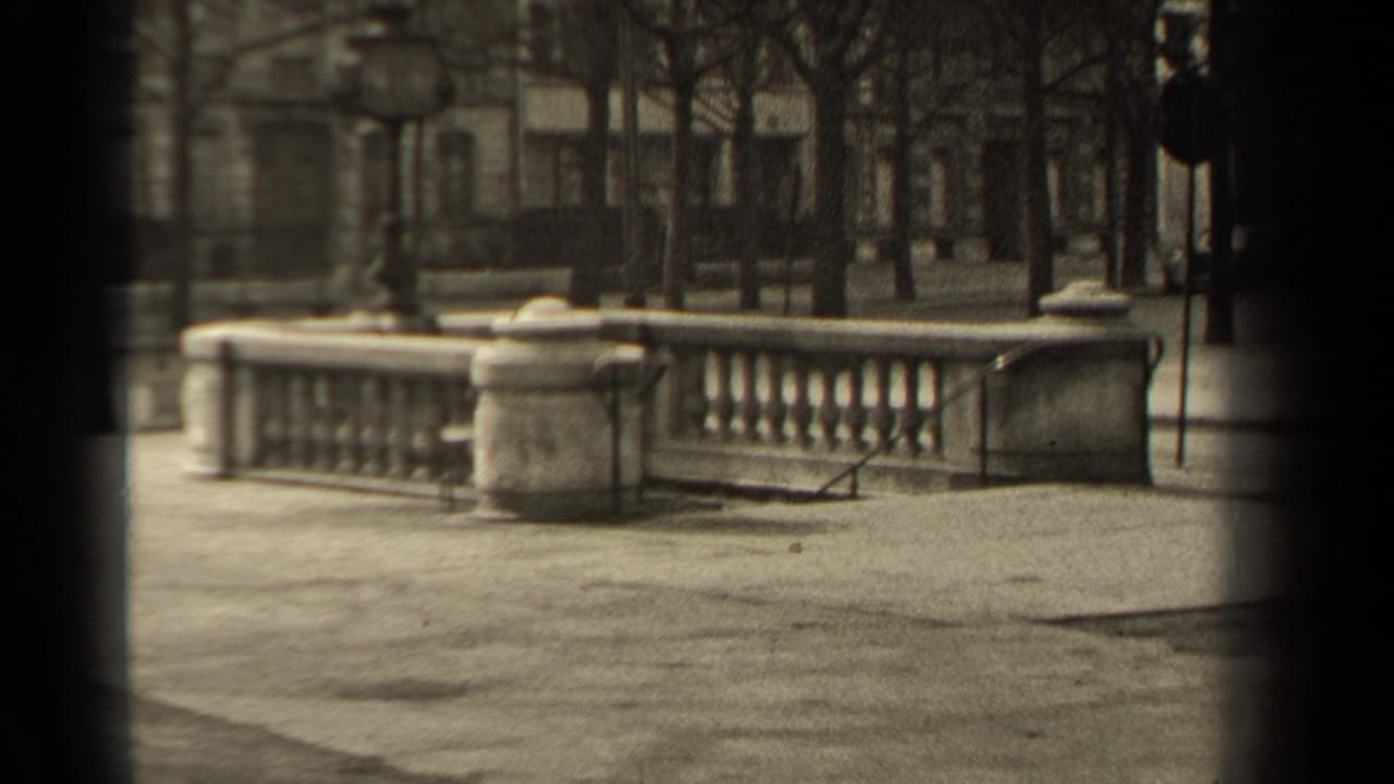 1947 Paris street view showing a stone balustrade, bare trees, lampposts, and soft-focus architecture in the background.