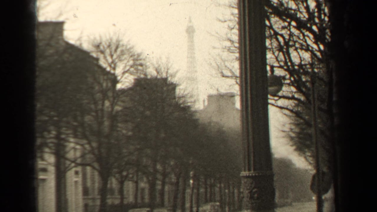 1947 Paris street view with the Eiffel Tower in the distance, framed by bare trees, a tall lamp, and dark film gate edges.