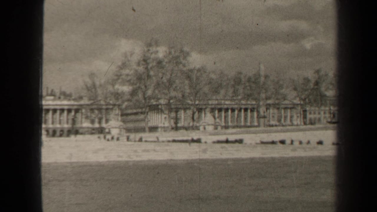 Final 1947 Paris frame holds on the same waterside architecture, with distant people and dark 8mm frame borders visible.