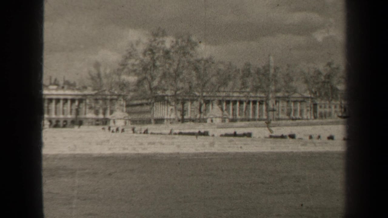Final 1947 Paris frame holding on the waterfront foreground and distant formal building lined by bare trees.