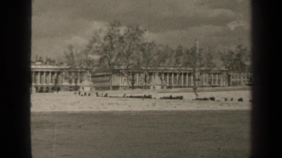 Final 1947 Paris frame holding on the waterfront foreground and distant formal building lined by bare trees.