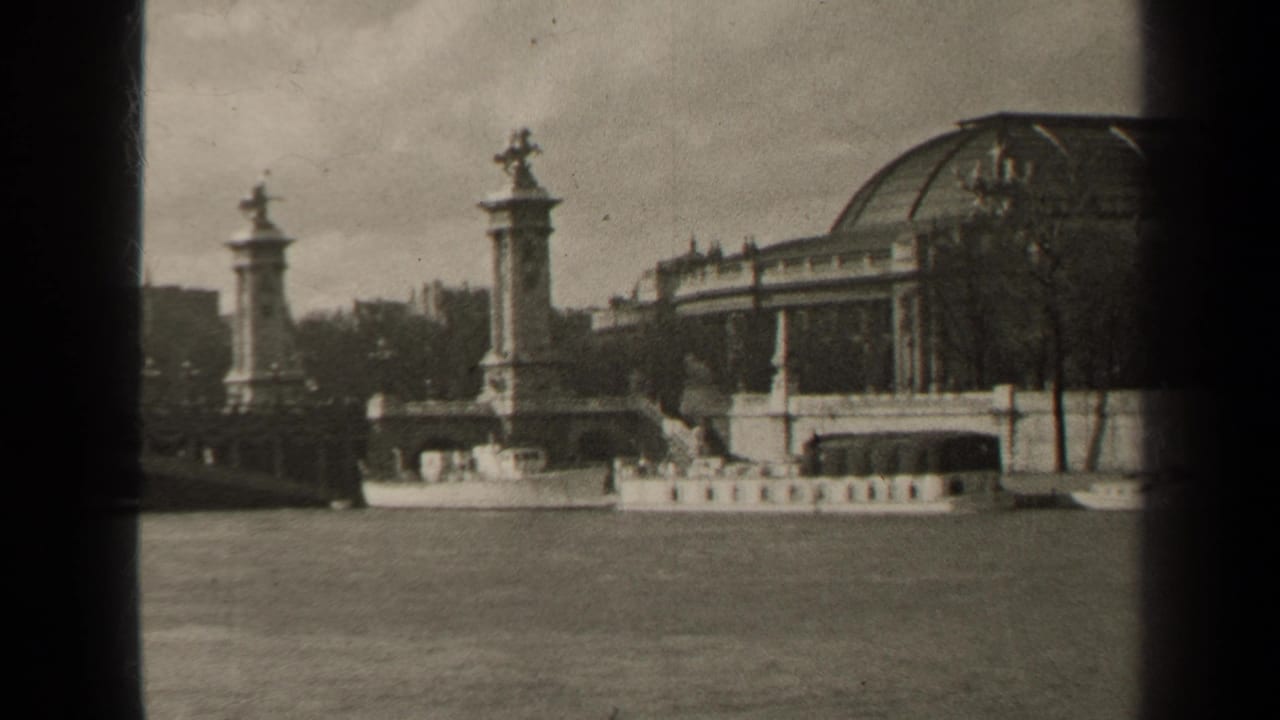 A 1947 Paris 8mm frame showing a riverboat on the Seine near Pont Alexandre III, with ornate pylons and a domed building behind.