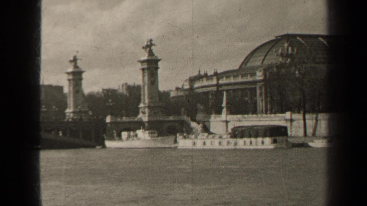 1947 Paris view across the Seine toward Pont Alexandre III, a domed riverside building, and a small boat near the embankment.