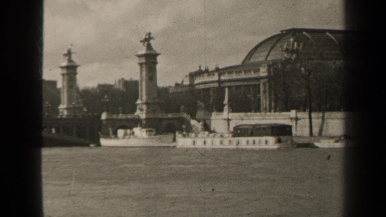 1947 Paris riverside architecture with stone bridge pylons, sculptural figures, the Seine, and a large domed public building in the background.