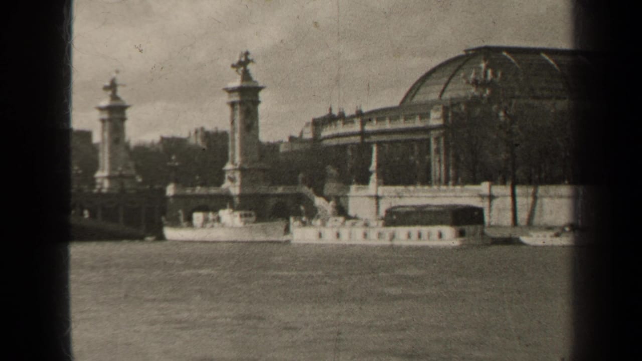 Similar riverside view with stone pylons, statues, water, trees, and a domed roofline.