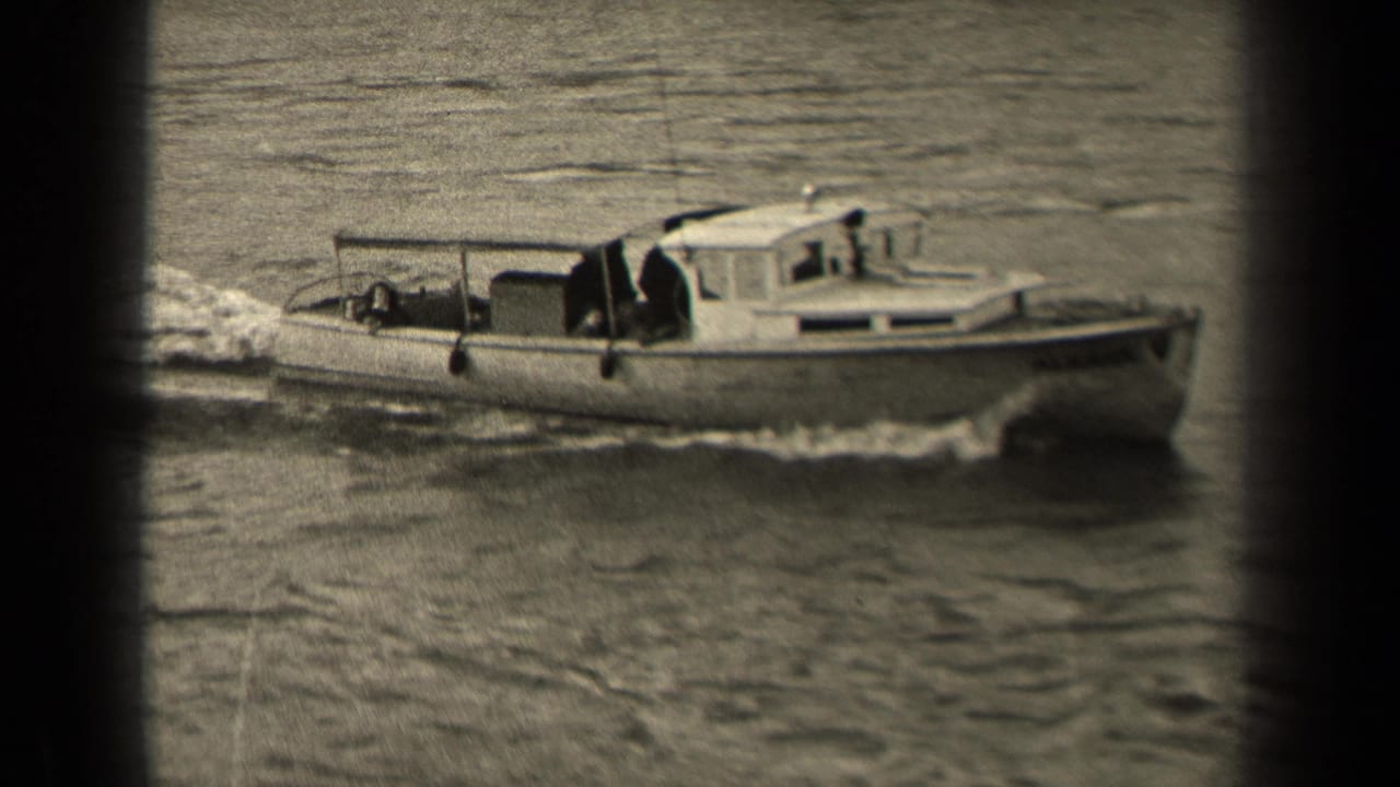 Black-and-white 1947 Paris river shot showing a small motorboat in profile with a cabin, open stern area, and rippling wake.