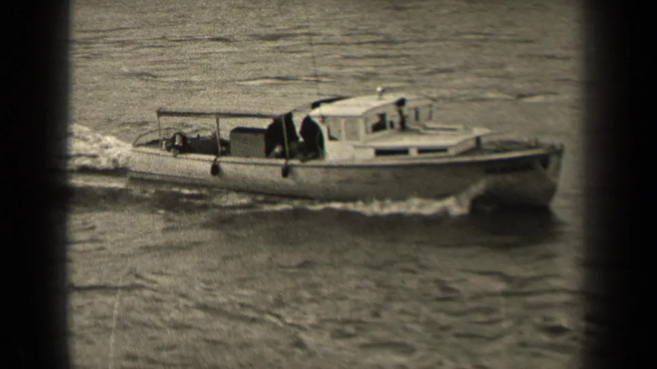 Black-and-white 1947 Paris river shot showing a small motorboat in profile with a cabin, open stern area, and rippling wake.