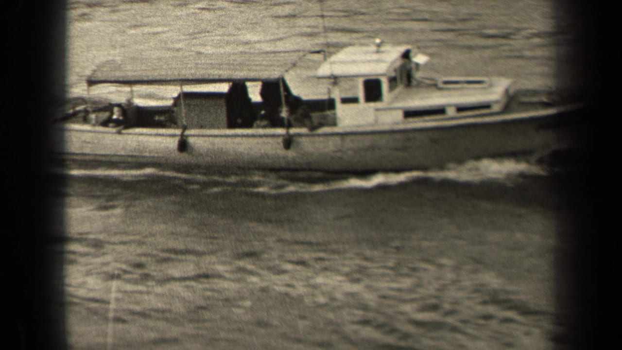 A closer side view shows the small motorboat moving past the camera, with a person near the bow area and the cabin visible against rippled water.