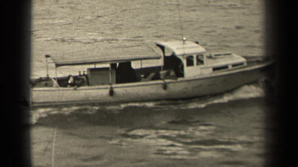 A closer black-and-white frame shows the motorboat’s cabin and covered midsection as it moves through the river, leaving churned water beside the hull.