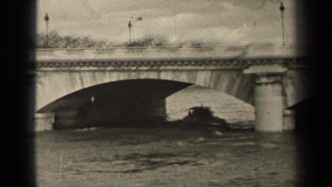 1947 Paris frame of a stone bridge and calm water, with a dark boat-like form under the arch and small pedestrians or traffic on the deck.