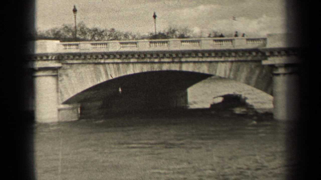 Boat partly under a stone bridge, with pedestrians and lampposts visible along the top.