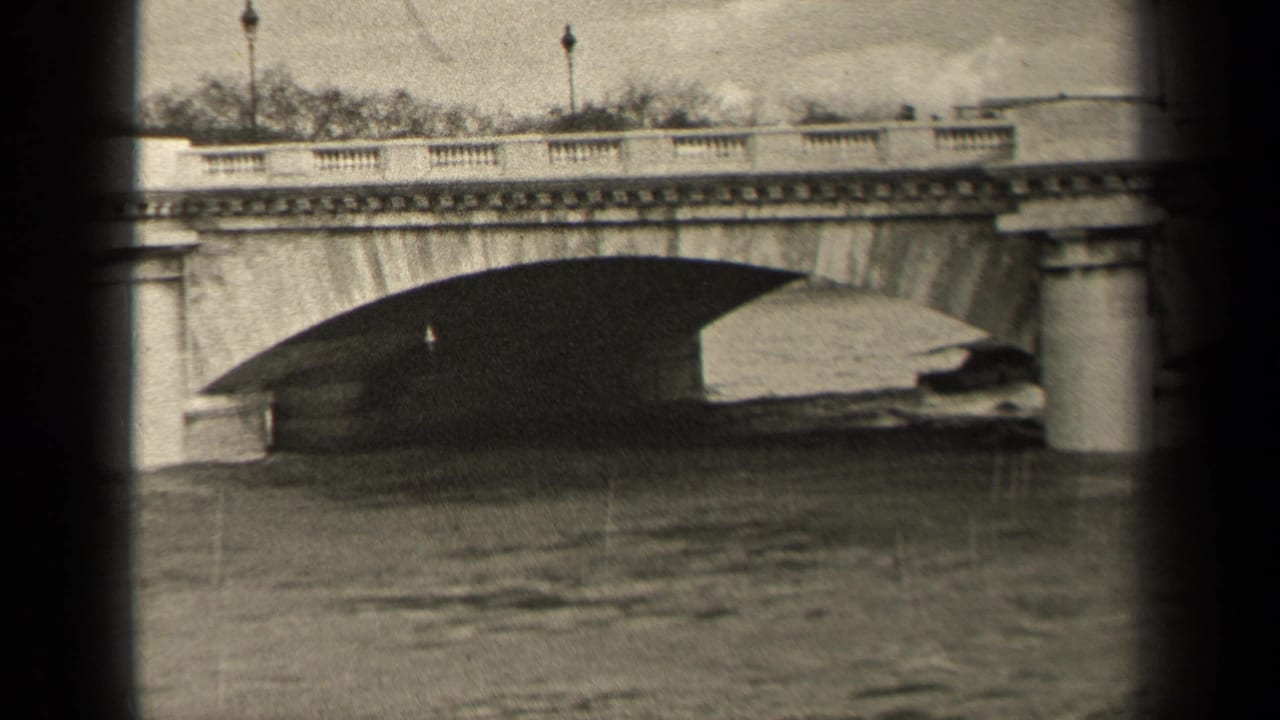 1947 Paris frame showing the boat near the far side of a stone bridge arch, with pedestrians and lampposts silhouetted above.