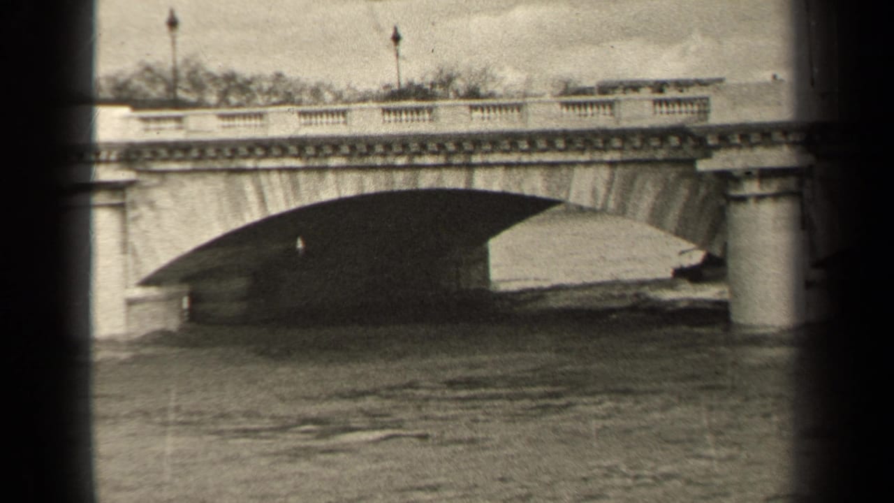 Stone bridge over water seen through dark film-frame edges.