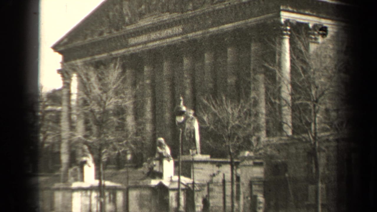 1947 Paris frame holding on a neoclassical public monument with columns, statues, bare trees, lamps, and an iron fence.