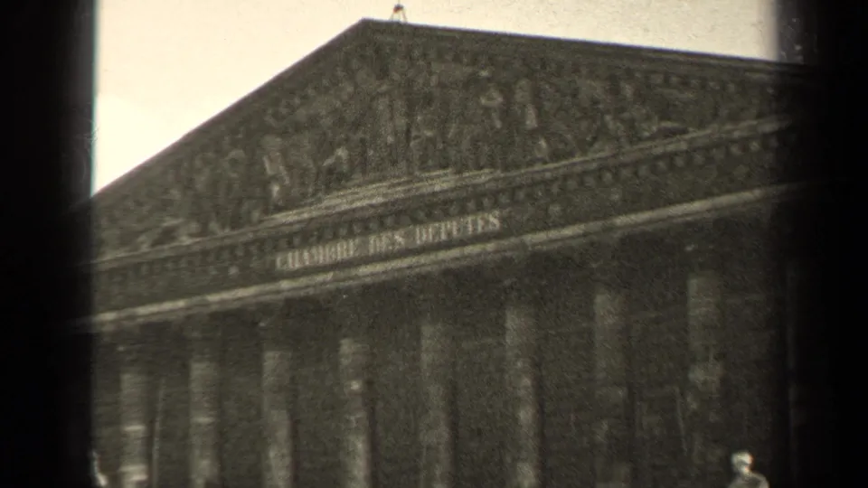Soft 8mm view of the Chambre des Deputes exterior in Paris, showing the pediment, columns, and part of the roofline.