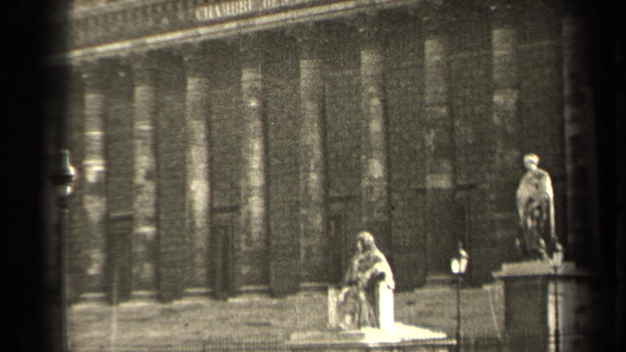 End frame of the 1947 Paris civic facade, with columns, statues on plinths, steps, and small figures near the entrance.