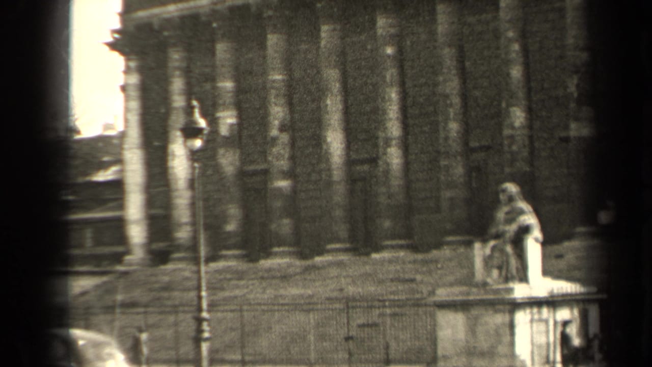 1947 Paris 8mm view of a lamppost, stone statue, railings, and a partially seen car beside a grand facade.